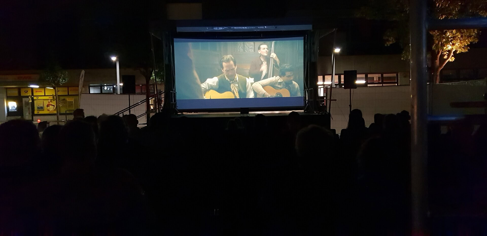 Freiluftkino zeigt Film bei Nacht.